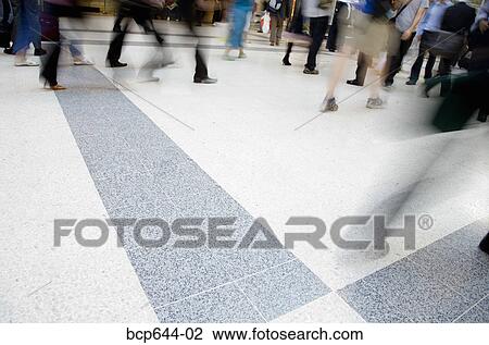 Stock Image - Blurred view of people walking through Liverpool Street Station, London, United Kingdom . Fotosearch