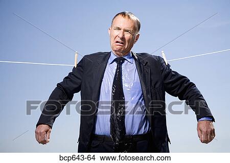 Picture - Businessman hung out to dry. Fotosearch
