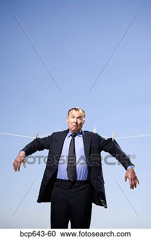 Businessman hung out to dry View Large Photo Image Stock Image - Businessman hung out to dry. Fotosearch