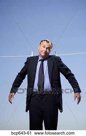 Stock Image - Businessman hung out to dry. Fotosearch