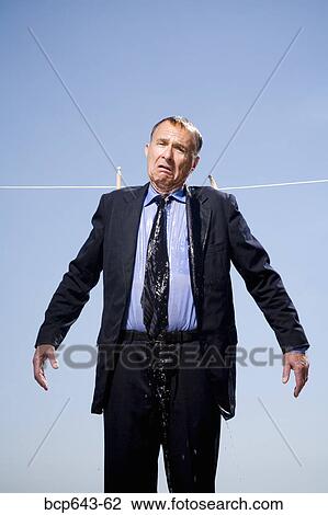 Stock Image - Businessman hung out to dry. Fotosearch