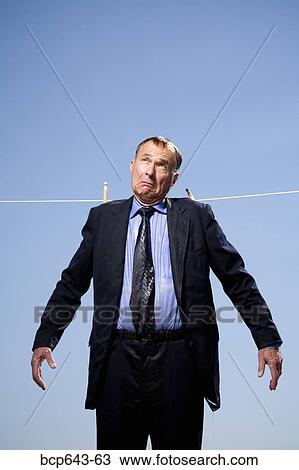 Businessman hung out to dry View Large Photo Image Stock Image - Businessman hung out to dry. Fotosearch