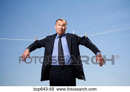 Businessman hung out to dry View Large Photo Image Stock Photo - Businessman hung out to dry. Fotosearch