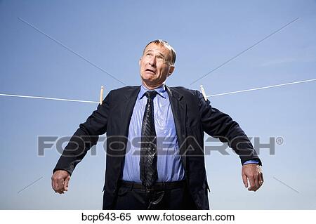 Stock Photography - Businessman hung out to dry. Fotosearch