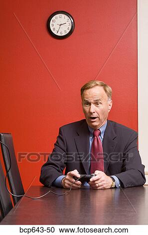 Businessman playing video games View Large Photo Image Stock Image - Businessman playing video games. Fotosearch
