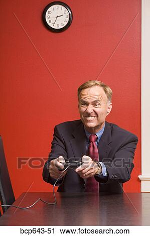 Businessman playing video games View Large Photo Image Stock Image - Businessman playing video games. Fotosearch
