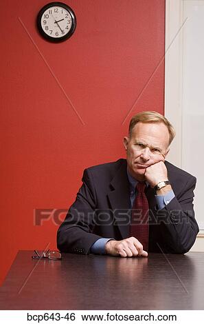 Businessman waiting alone at conference table View Large Photo Image Stock Photograph - Businessman waiting alone at conference table. Fotosearch