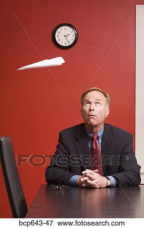 Businessman watching paper airplane View Large Photo Image Stock Photo - Businessman watching paper airplane. Fotosearch
