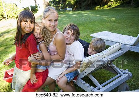 Stock Image - Children playing in the backyard. Fotosearch