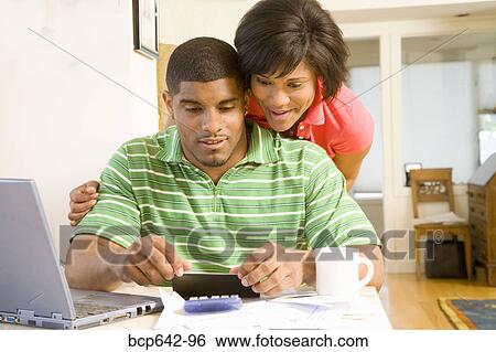 Couple doing their finances together View Large Photo Image Stock Photograph - Couple doing their finances together. Fotosearch