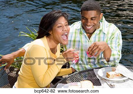 Couple eating by lake View Large Photo Image Stock Image - Couple eating by lake. Fotosearch