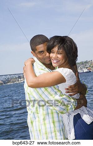 Couple hugging by bay View Large Photo Image Stock Photo - Couple hugging by bay. Fotosearch