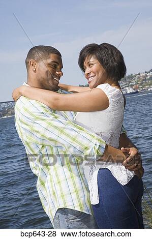 Couple hugging by bay View Large Photo Image Stock Photo - Couple hugging by bay. Fotosearch