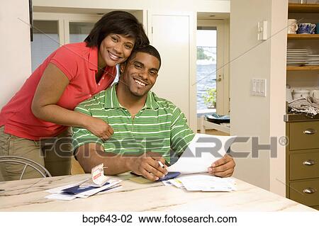 Couple reading mail together View Large Photo Image Stock Image - Couple reading mail together. Fotosearch