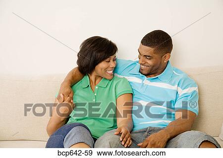 Couple sitting together View Large Photo Image Stock Photo - Couple sitting together. Fotosearch