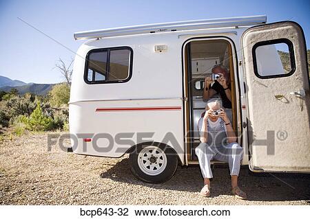 Couple taking pictures from their trailer View Large Photo Image Stock Image - Couple taking pictures from their trailer. Fotosearch