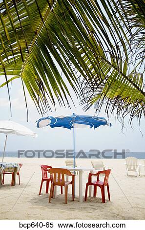 Stock Photography - Empty tables on beach. Fotosearch