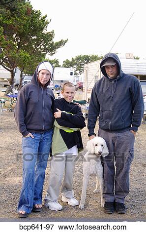 Stock Photo - Family standing together in trailer park. Fotosearch