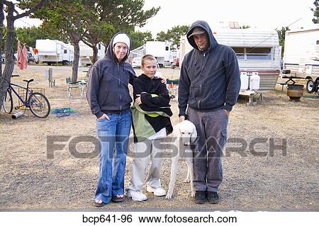 Family standing together in trailer park View Large Photo Image Stock Photograph - Family standing together in trailer park. Fotosearch