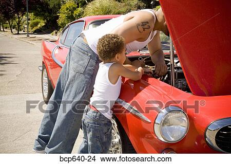 Father and son checking under car hood View Large Photo Image Picture - Father and son checking under car hood. Fotosearch