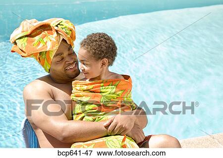 Father and son drying off by pool View Large Photo Image Stock Photo - Father and son drying off by pool. Fotosearch
