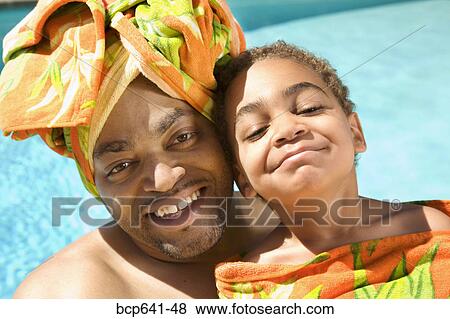 Father and son drying off by pool View Large Photo Image Stock Photo - Father and son drying off by pool. Fotosearch