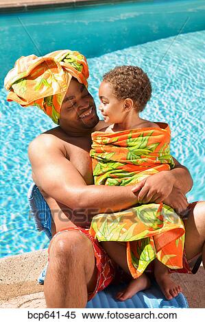 Father and son drying off by pool View Large Photo Image Stock Photography - Father and son drying off by pool. Fotosearch