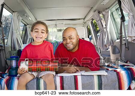 Father and son sitting in trunk of car with camping gear View Large Photo Image Stock Image - Father and son sitting in trunk of car with camping gear. Fotosearch