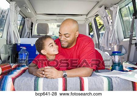 Father and son sitting in trunk of car with camping gear View Large Photo Image Stock Photo - Father and son sitting in trunk of car with camping gear. Fotosearch