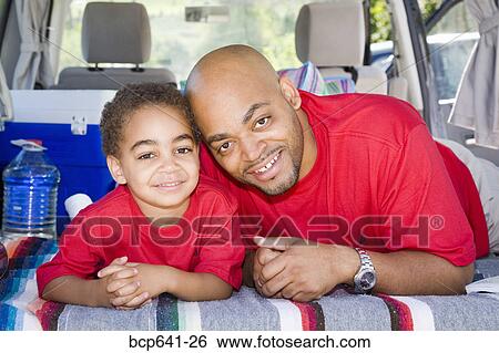 Father and son sitting in trunk of car with camping gear View Large Photo Image Stock Photograph - Father and son sitting in trunk of car with camping gear. Fotosearch