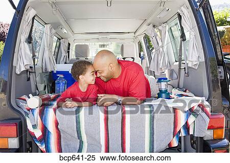 Father and son sitting in trunk of car with camping gear View Large Photo Image Stock Photography - Father and son sitting in trunk of car with camping gear. Fotosearch