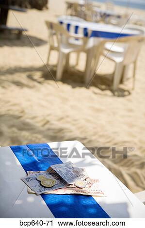 Stock Image - Foreign currency on table. Fotosearch