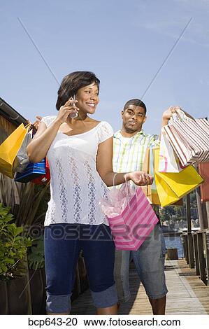 Man carrying his wife’s shopping bags View Large Photo Image Stock Image - Man carrying his wife’s shopping bags. Fotosearch