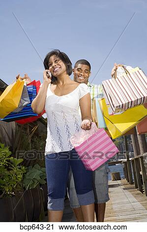 Man carrying his wife’s shopping bags View Large Photo Image Stock Image - Man carrying his wife’s shopping bags. Fotosearch
