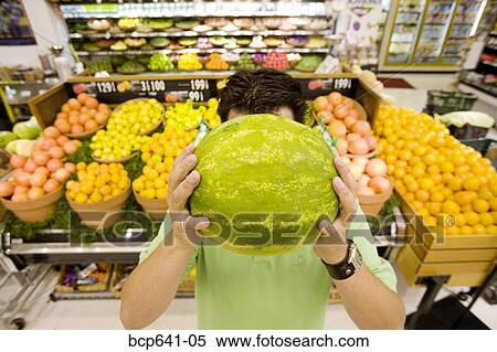 Man holding watermelon in supermarket View Large Photo Image Stock Photography - Man holding watermelon in supermarket. Fotosearch