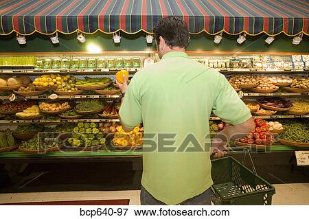 Man selecting produce in supermarket View Large Photo Image Stock Photo - Man selecting produce in supermarket. Fotosearch