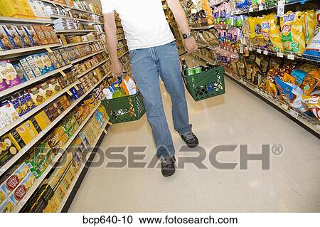 Man shopping in supermarket View Large Photo Image Stock Image - Man shopping in supermarket. Fotosearch