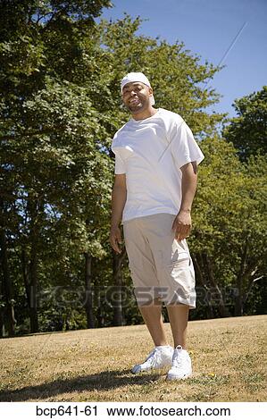 Stock Image - Man standing outdoors. Fotosearch