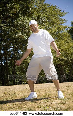Man standing outdoors View Large Photo Image Stock Image - Man standing outdoors. Fotosearch