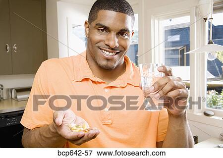 Man taking a handful of pills View Large Photo Image Stock Photo - Man taking a handful of pills. Fotosearch