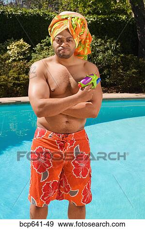 Stock Photo - Man wearing towel turban by pool. Fotosearch