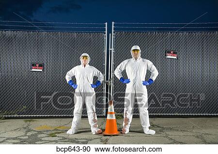 People in biohazard suits standing around orange safety cone View Large Photo Image Stock Image - People in biohazard suits standing around orange safety cone. Fotosearch
