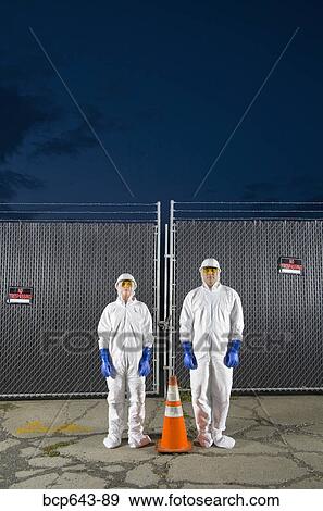 People in biohazard suits standing around orange safety cone View Large Photo Image Stock Photo - People in biohazard suits standing around orange safety cone. Fotosearch