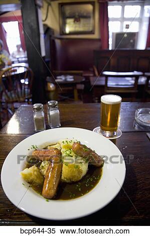 Plate of potatoes and sausages in a pub, Gloucestershire, United Kingdom View Large Photo Image Stock Photography - Plate of potatoes and sausages in a pub, Gloucestershire, United Kingdom. Fotosearch