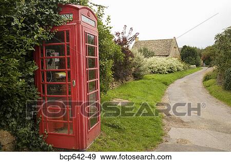 Stock Photo - Red telephone booth in rural community. Fotosearch
