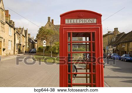 Stock Photo - Red telephone booth in town, Gloucestershire, United Kingdom. Fotosearch