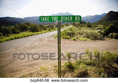 Stock Photo - Rural street sign reading “Take The Other Rd”. Fotosearch