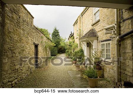 Stone cottages and wall, Gloucestershire, United Kingdom View Large Photo Image Stock Photography - Stone cottages and wall, Gloucestershire, United Kingdom. Fotosearch