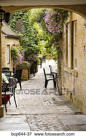 Stock Photo - Stone path between cottages, Gloucestershire, United Kingdom. Fotosearch