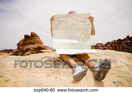 Stock Image - Tourist reading map, Moab, Canyonlands, Utah, United States. Fotosearch